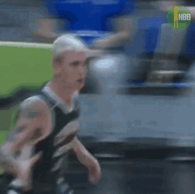 a blurry picture of a basketball player with the nbb logo in the corner