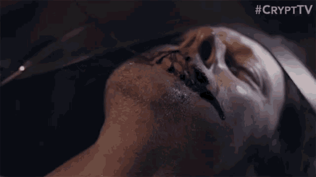 a close up of a man 's face with blood coming out of it