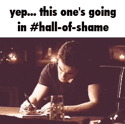 a man is writing on a piece of paper at a table .
