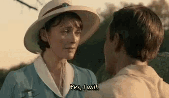 a man and a woman are standing next to each other and the woman is saying `` yes , i will '' .