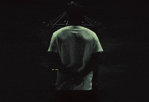 a man standing in front of a bird cage