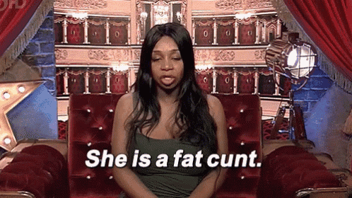 a woman is sitting in a chair and says she is a fat cunt