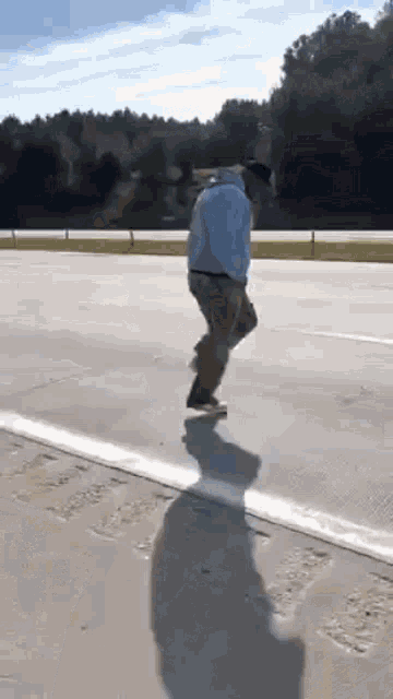 a man is riding a skateboard on the side of a road