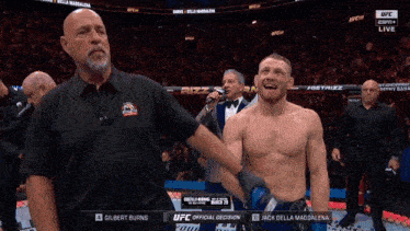 a referee holds up a fighter 's arm during a ufc match