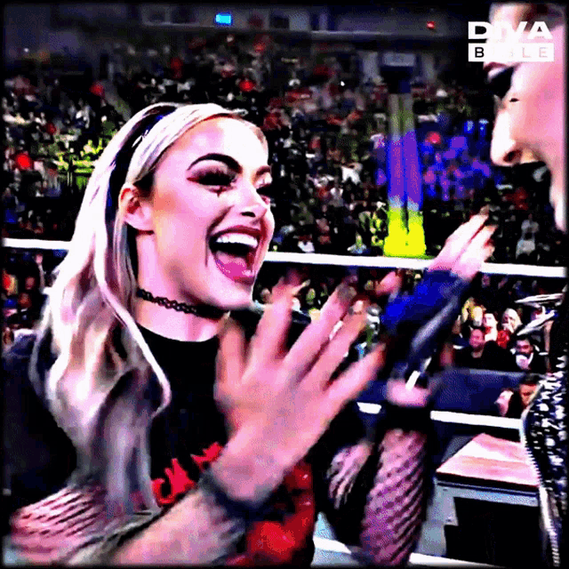 a woman is laughing in front of a diva bible sign