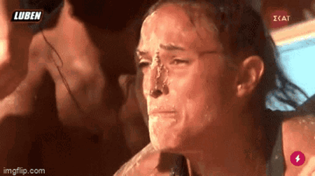 a woman is crying with a man behind her and the words luben on the bottom