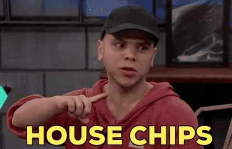 a man wearing a red hoodie and a black hat points at the word house chips