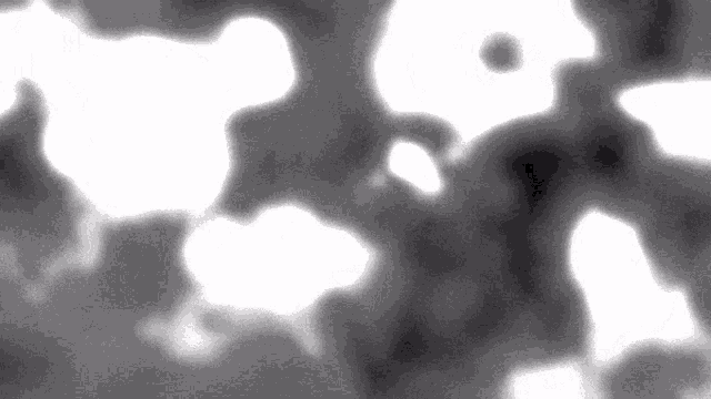 a black and white image of a cloudy sky with a few white clouds