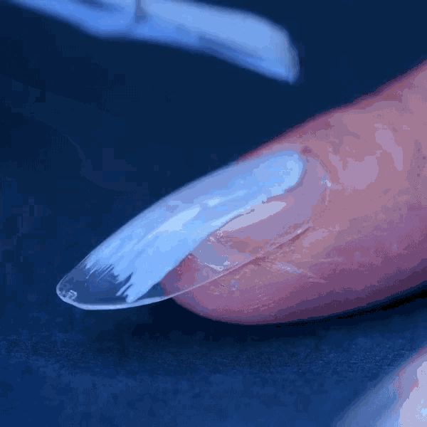 a close up of a person applying nail polish on their nails