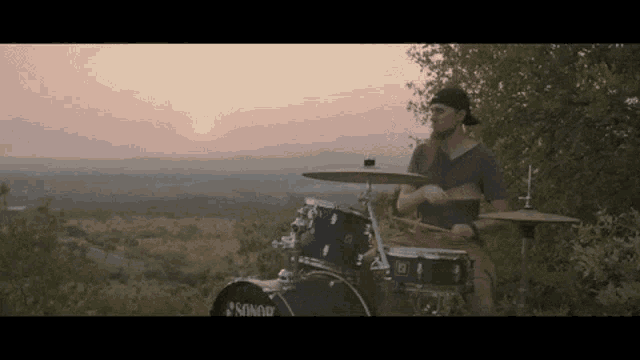 a man is playing drums with a sonor drum set