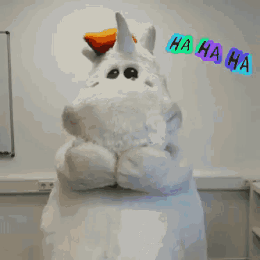 a stuffed unicorn is laughing with ha ha ha written above it