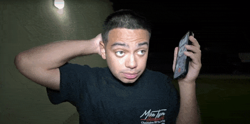 a man wearing a black shirt that says ' miss tori ' on it