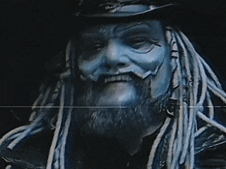 a man with dreadlocks and a beard is wearing a top hat