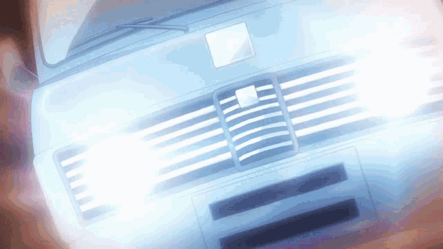 a close up of a car 's headlights with a white square on the front