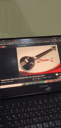 a laptop screen shows a picture of a drone c