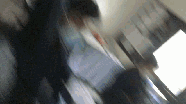 a blurry picture of a person walking down a escalator