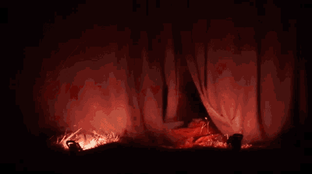 a red light is shining through a tent