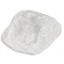 a large piece of clear quartz is sitting on a white surface .