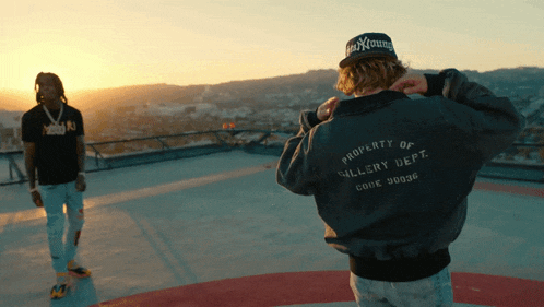 a man wearing a black jacket that says property of gallery dept
