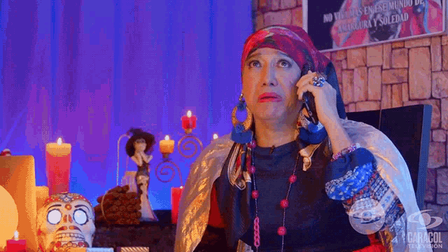 a woman is talking on a cell phone in front of a sign that says caracol