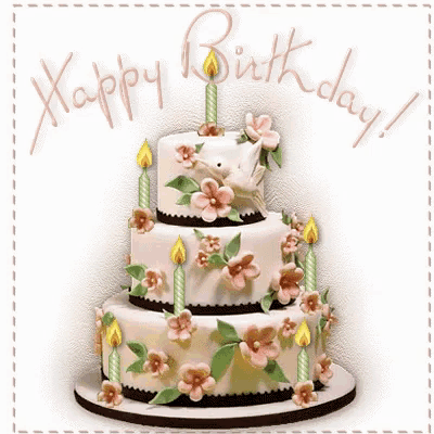 a birthday cake with flowers and candles and the words happy birthday written above it