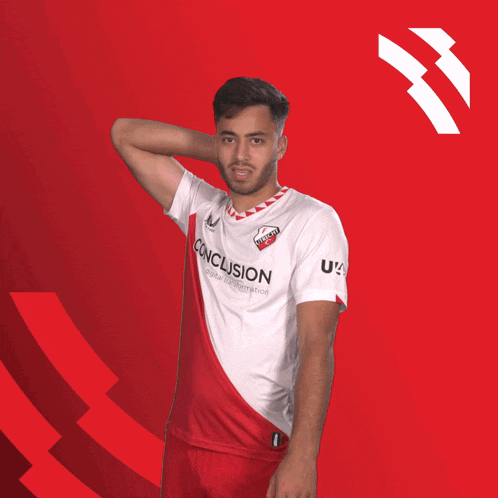 a man wearing a red and white conclusion shirt