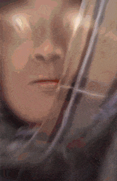 a close up of a person 's face with a reflection of another person