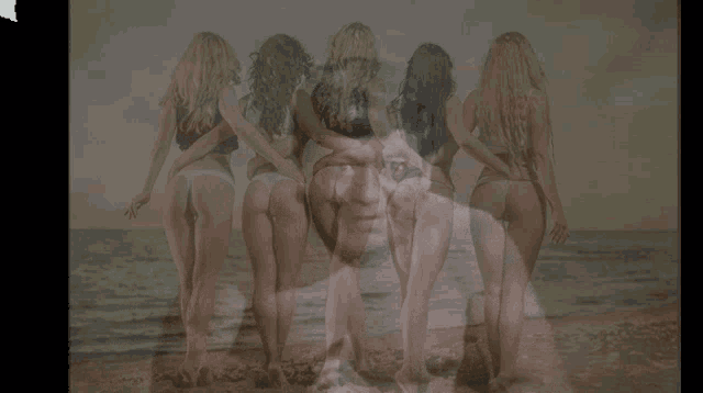 a group of women are standing on a beach with a man in the foreground