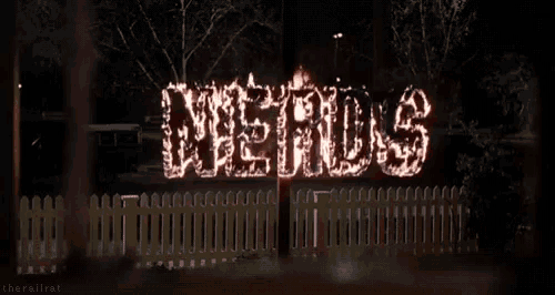 a sign that says nerds is lit up at night