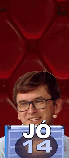 a man wearing glasses is holding a box that says jo 14 on it