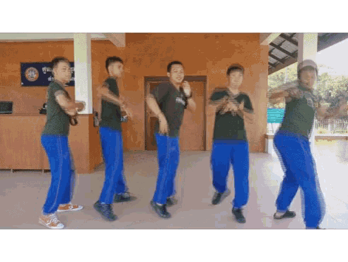 a group of soldiers are dancing in front of a sign that says ' military ' on it