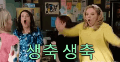 a group of women are standing in a room with korean writing on the wall behind them
