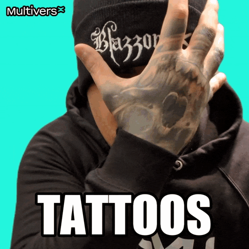 a man with a tattoo on his hand is wearing a beanie that says blazer