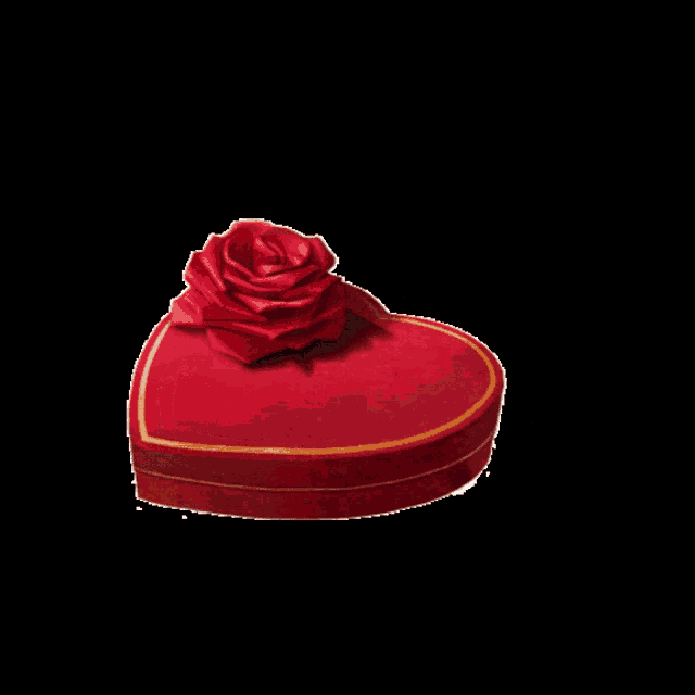 a red heart shaped box filled with chocolates