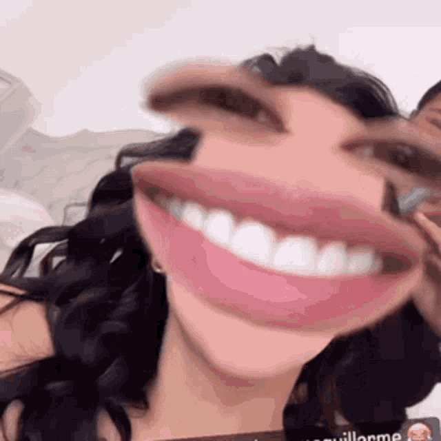 a close up of a woman 's face with a big mouth and teeth .