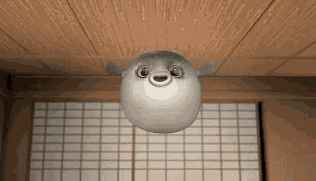 a cartoon puffer fish is hanging from the ceiling