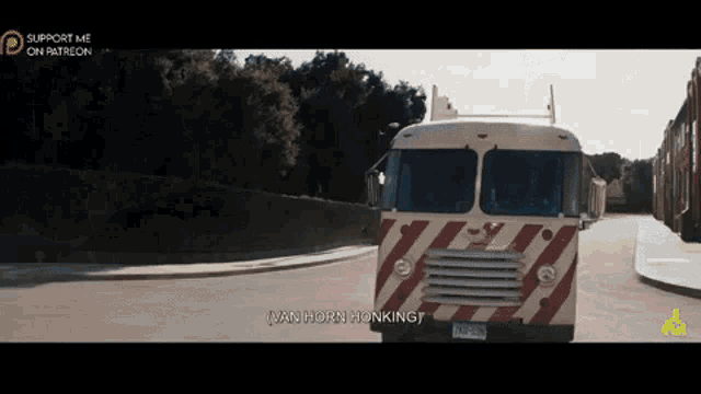 a van horn honking is driving down a road