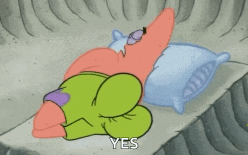 patrick star from spongebob squarepants is sleeping on a bed .