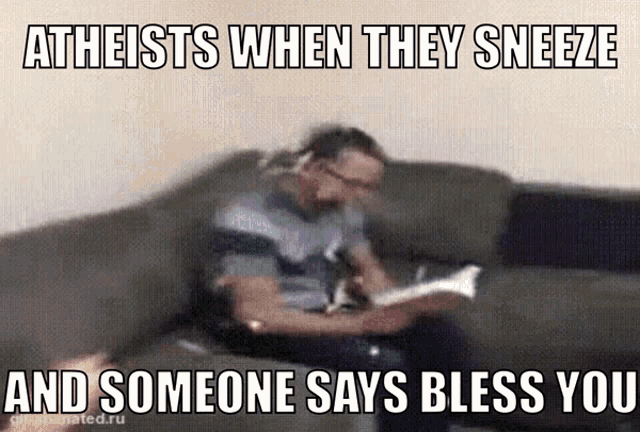 a man is sitting on a couch reading a book and someone says bless you in a meme