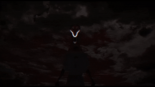 a dark background with a glowing face in the middle of it .