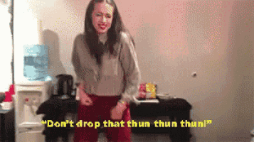 a woman is dancing in a room with the words " don 't drop that thun thun thun " on the bottom
