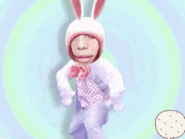 a person in a bunny costume with a speech bubble that has hearts on it