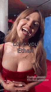 a woman in a red dress is laughing and says `` love you ethan '' .