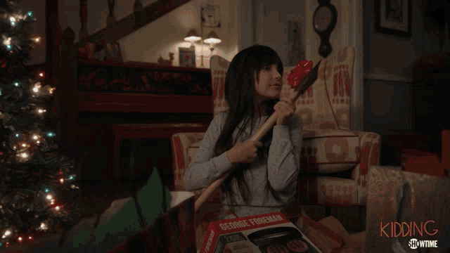 a girl holding an axe in front of a christmas tree with the words i love you axe below her