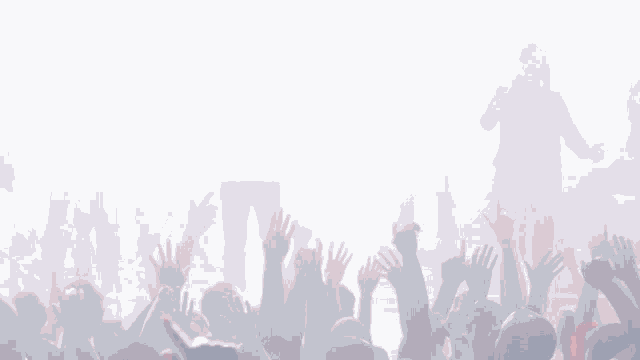 a crowd at a concert with their hands up in the air