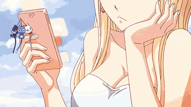 a woman is holding a cell phone with a cat on it