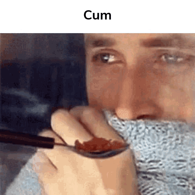 a man is eating a spoonful of food with chopsticks while wearing a scarf around his neck .