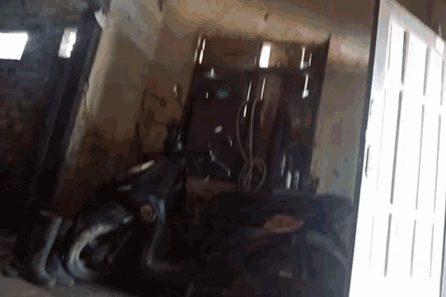 a motorcycle is parked in a garage with a license plate that says ' ae ' on it
