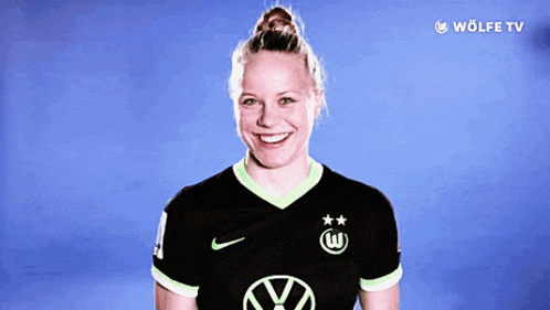 a woman wearing a black shirt with a vw logo on it