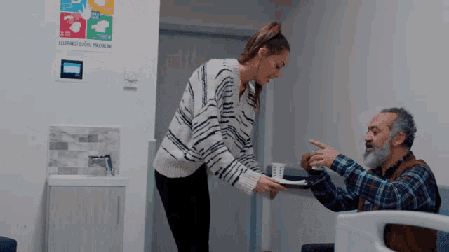 a woman standing next to an older man in a hospital bed